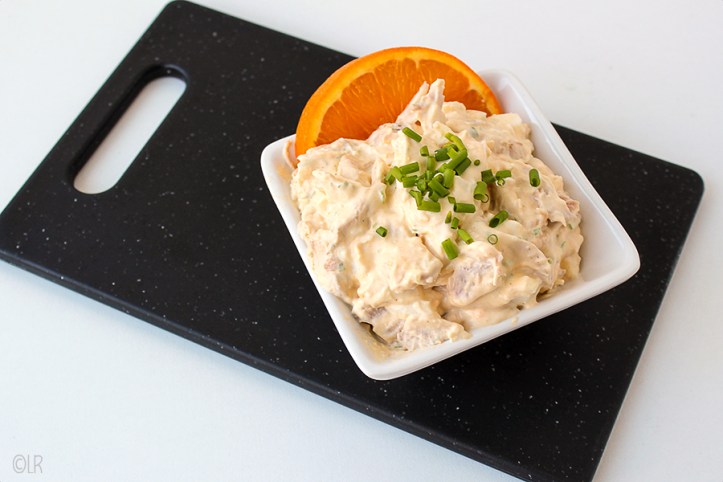 Schaaltje romige kipsalade met ei, roomkaas, mayonaise en sinaasappel.